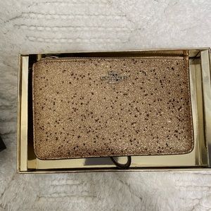 Rose gold Coach wristlet/wallet.